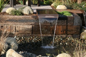 Waterfall with railway sleepers backing. Nice design and has a natural rustic feel to it. 